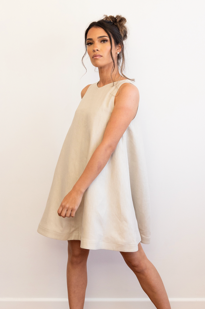 High neck, Shift dress. Full skirt, structured waistband, bespoke button, keyhole opening, quality heavy weight Linen. Colour Bone.